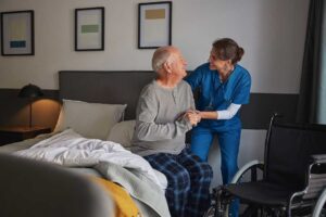 Older adult and family member reviewing an assisted living contract and fee worksheet at a table.